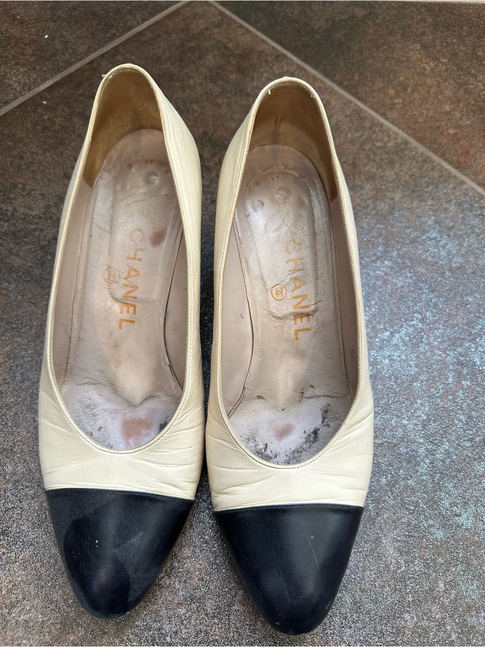 CHANEL Two-Tone Leather Cap-Toe Pumps in Cream and Black